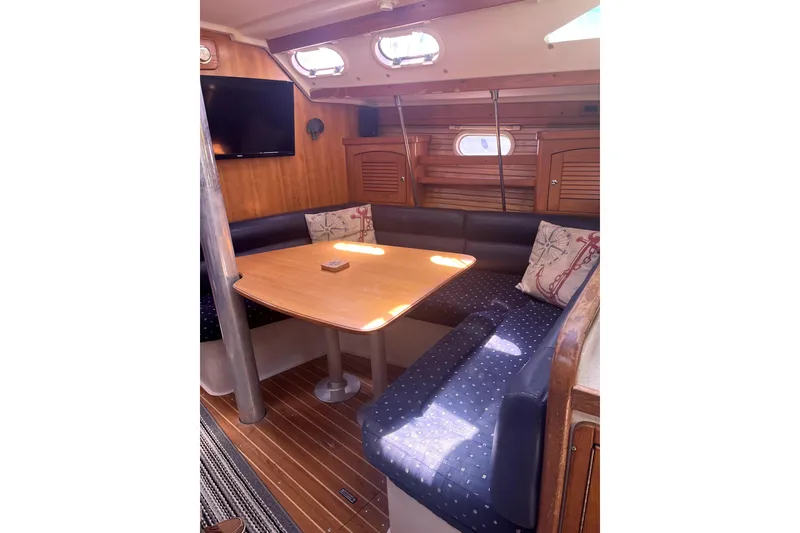Slide: The Image of Cozy interior of 2006 Catalina 400 MkII sailboat with dining area and wooden accents. - 21