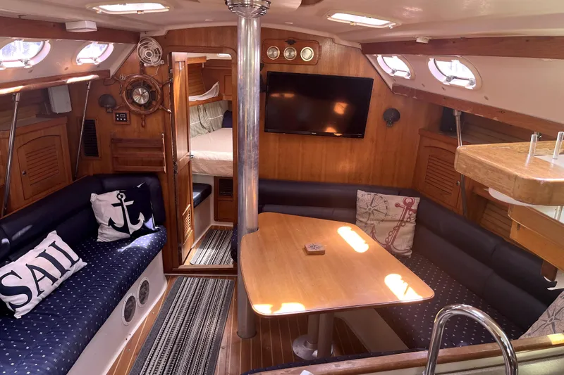 Slide: The Image of Interior of 2006 Catalina 400 MkII sailboat with cozy seating and nautical decor. - 22