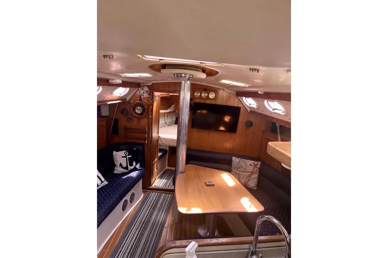 Slide: The Image of Interior of 2006 Catalina 400 MkII sailboat with cozy seating and wooden finishes. - 23