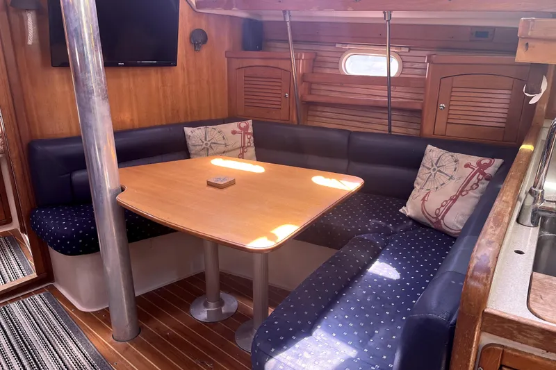 Slide: The Image of Cozy interior of 2006 Catalina 400 MkII sailboat with dining area and nautical decor. - 24