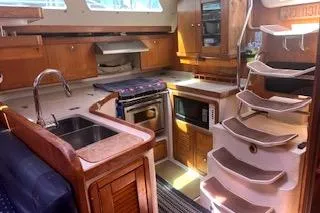 Slide: The Image of 2006 Catalina 400 MkII yacht interior with modern kitchen and wooden cabinetry. - 27