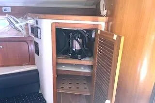 Slide: The Image of 2006 Catalina 400 MkII yacht interior with open wooden cabinet and coffee maker. - 29
