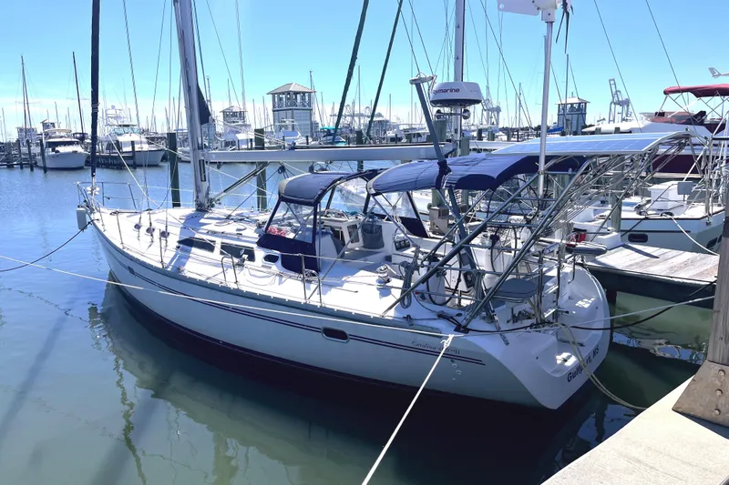 Slide: The Image of 2006 Catalina 400 MkII sailboat docked in a marina under clear blue skies. - 3
