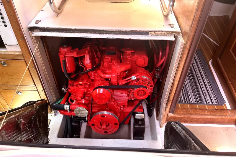 Slide: The Image of Engine compartment of a 2006 Catalina 400 MkII sailboat, featuring a vibrant red engine. - 37