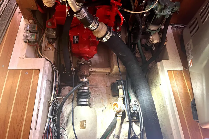 Slide: The Image of Engine compartment of a 2006 Catalina 400 MkII sailboat, showcasing mechanical components and wiring. - 38