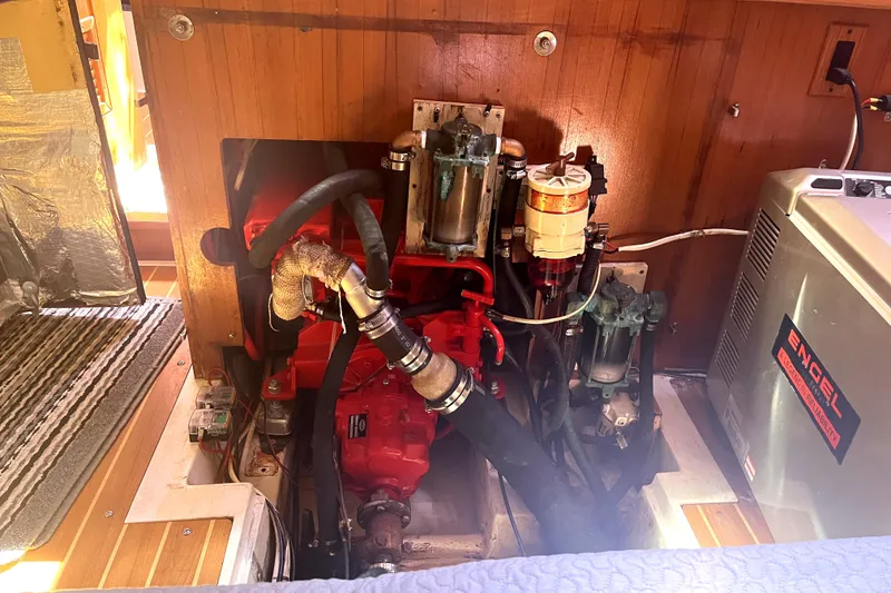 Slide: The Image of Engine compartment of a 2006 Catalina 400 MkII sailboat, featuring mechanical components. - 39