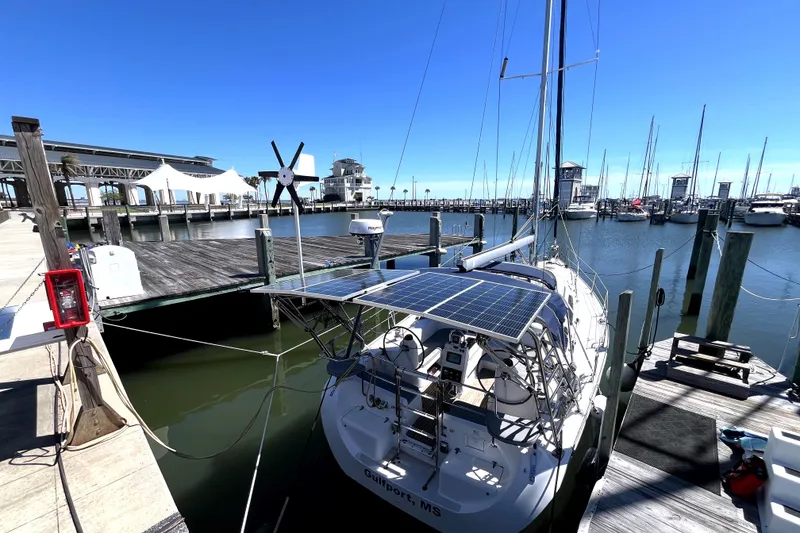 Slide: The Image of Catalina 400 MkII 2006 sailboat docked at marina with solar panels and clear blue sky. - 5