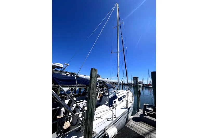 Slide: The Image of 2006 Catalina 400 MkII sailboat docked under clear blue sky. - 6