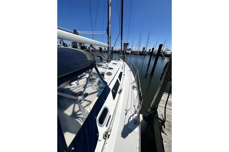 Slide: The Image of 2006 Catalina 400 MkII sailboat docked at marina under clear blue sky. - 7