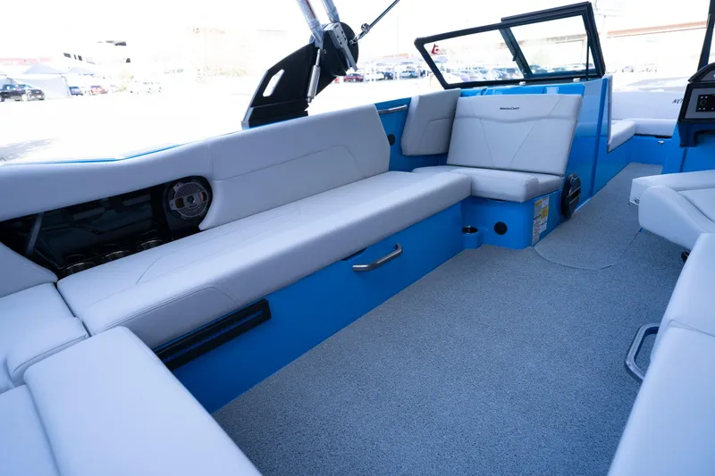 Slide: The Image of 2022 MasterCraft NXT24 boat interior with blue and white seating. - 12