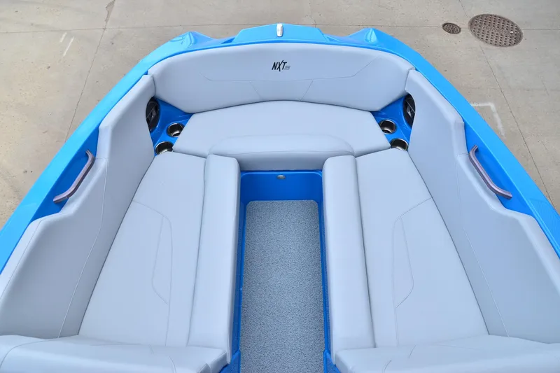 Slide: The Image of 2022 MasterCraft NXT24 boat interior with blue and white seating. - 8