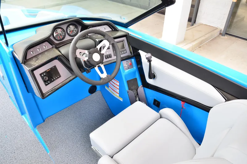 Slide: The Image of 2022 MasterCraft NXT24 boat cockpit with modern steering and control panel. - 9