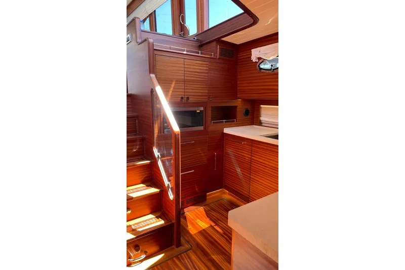 Slide: The Image of Luxurious interior of 2027 Vicem 62 Flybridge yacht with wooden cabinetry and stairs. - 10