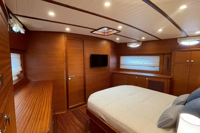 Slide: The Image of Luxurious cabin interior of 2027 Vicem 62 Flybridge yacht with wood paneling and modern amenities. - 12