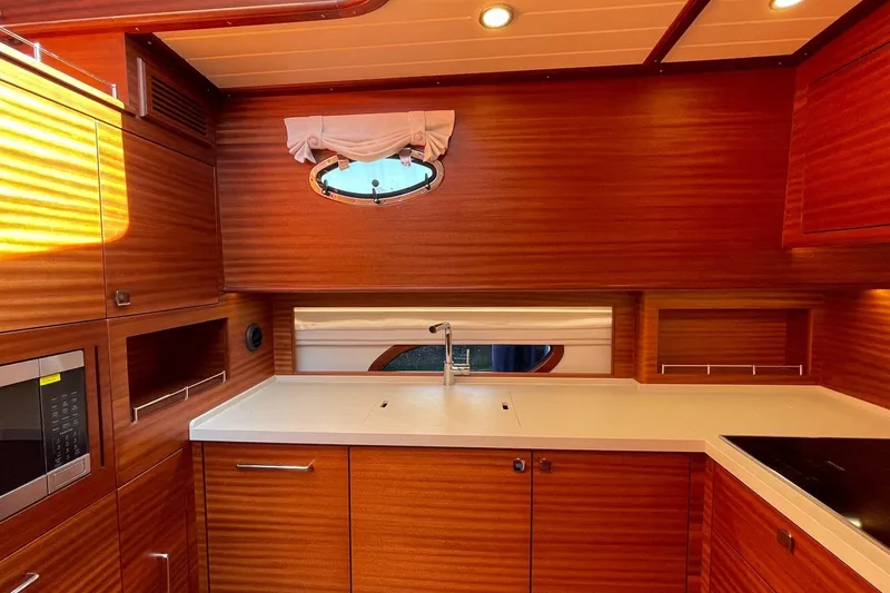 Slide: The Image of Luxurious kitchen interior of 2027 Vicem 62 Flybridge yacht with wood finish and modern appliances. - 13