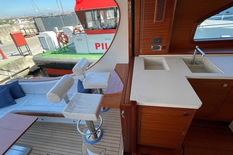 Slide: The Image of Luxurious interior of 2027 Vicem 62 Flybridge yacht with seating and kitchenette. - 15