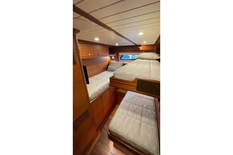 Slide: The Image of Luxurious cabin interior of 2027 Vicem 62 Flybridge yacht with wooden finishes and cozy bedding. - 16