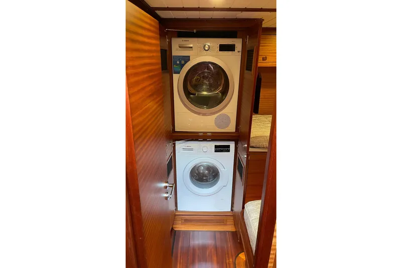 Slide: The Image of Laundry area with stacked washer and dryer on Vicem 62 Flybridge yacht, 2027 model. - 17