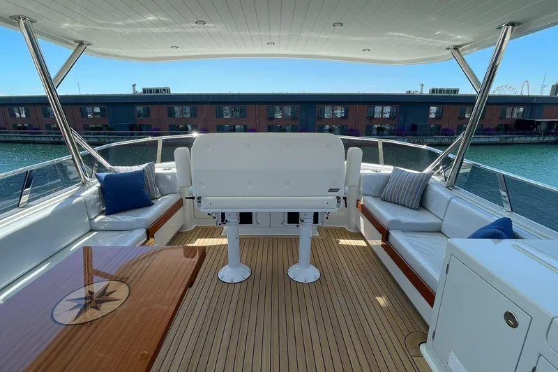 Slide: The Image of Luxurious 2027 Vicem 62 Flybridge yacht interior with elegant seating and wooden deck. - 7