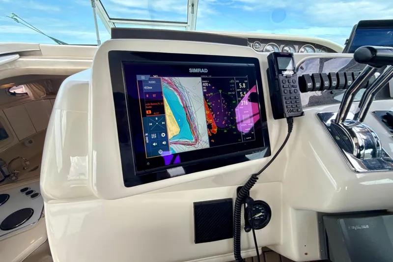 Slide: The Image of 1995 Sea Ray Sundancer 370 helm with Simrad navigation display and controls. - 11