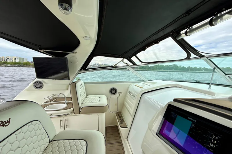 Slide: The Image of 1995 Sea Ray Sundancer 370 interior with seating, navigation system, and water view. - 13