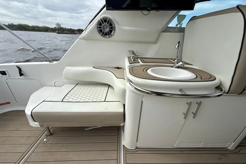 Slide: The Image of Interior of 1995 Sea Ray Sundancer 370 with seating and sink, overlooking water. - 16