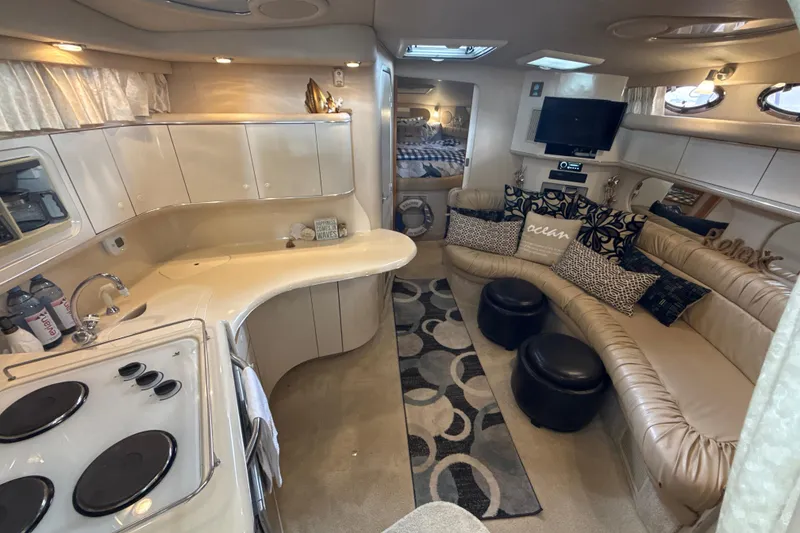 Slide: The Image of Luxurious 1995 Sea Ray Sundancer 370 interior with kitchen, seating, and cozy decor. - 23
