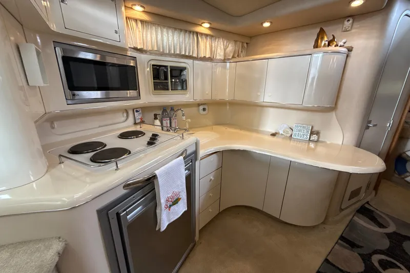 Slide: The Image of Interior of 1995 Sea Ray Sundancer 370 yacht kitchen with modern appliances and sleek cabinetry. - 28