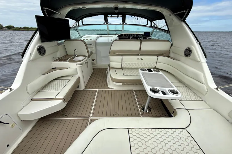 Slide: The Image of Luxurious 1995 Sea Ray Sundancer 370 boat interior with seating, table, and kitchenette. - 3