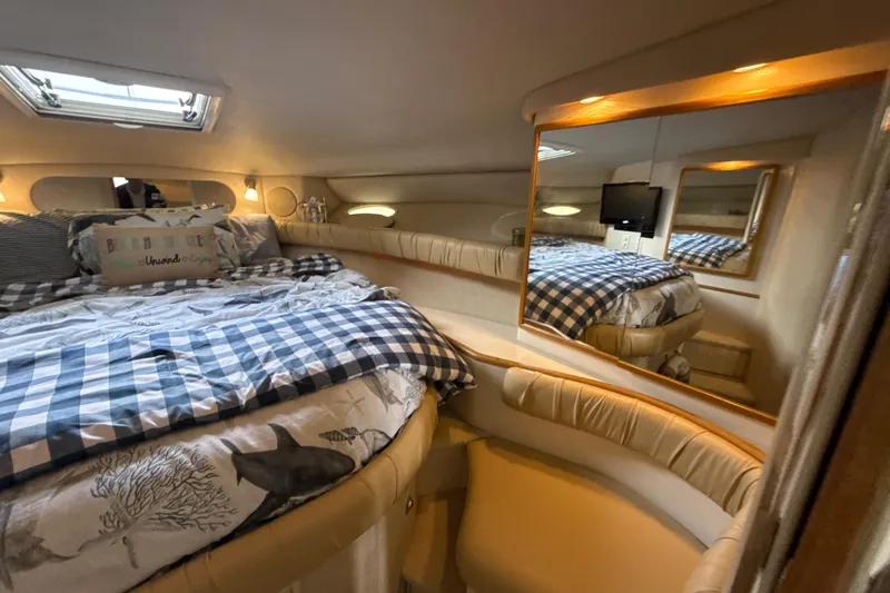 Slide: The Image of Cozy cabin interior of 1995 Sea Ray Sundancer 370 with bed and seating area. - 31