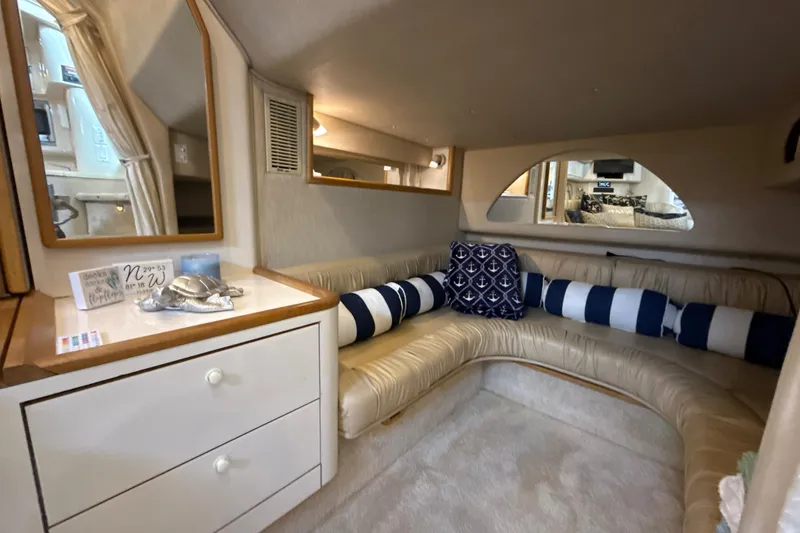 Slide: The Image of Interior of 1995 Sea Ray Sundancer 370 with cozy seating and nautical decor. - 32