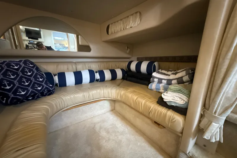 Slide: The Image of Interior cabin of 1995 Sea Ray Sundancer 370 with nautical-themed pillows and folded towels. - 33