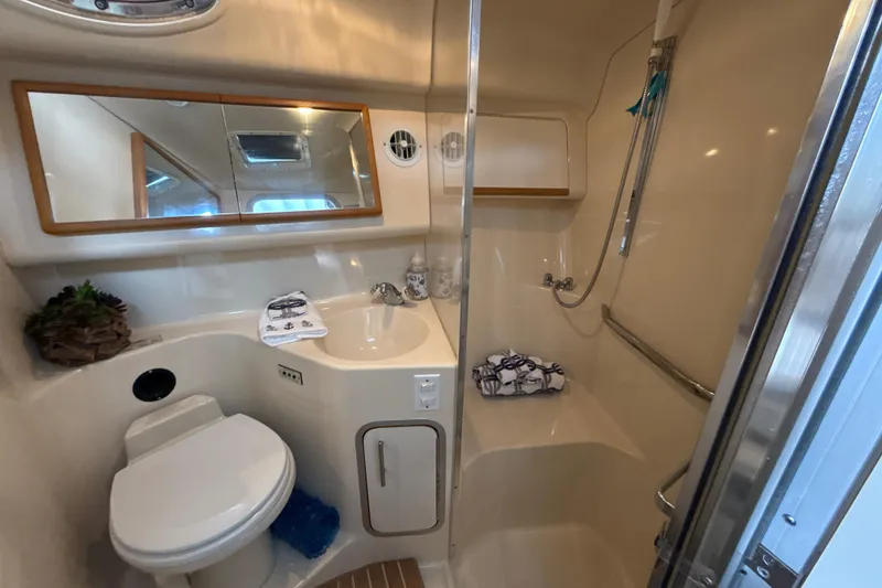 Slide: The Image of Bathroom interior of 1995 Sea Ray Sundancer 370 yacht, featuring shower, sink, and toilet. - 35