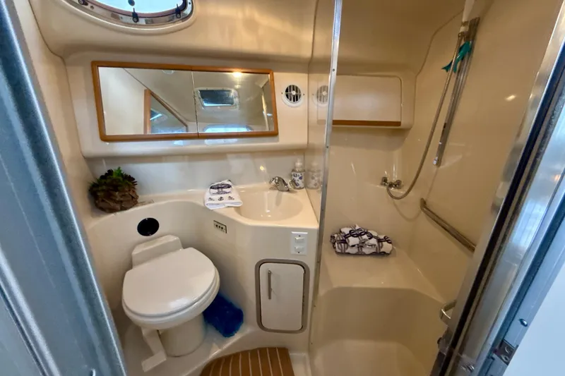 Slide: The Image of Bathroom interior of 1995 Sea Ray Sundancer 370 yacht, featuring toilet, sink, and shower. - 39