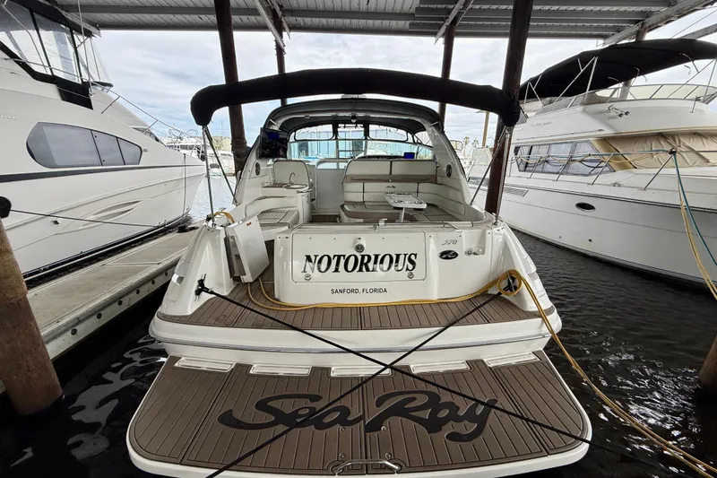 Slide: The Image of 1995 Sea Ray Sundancer 370 docked, rear view with "Notorious" nameplate, in Sanford, Florida. - 41
