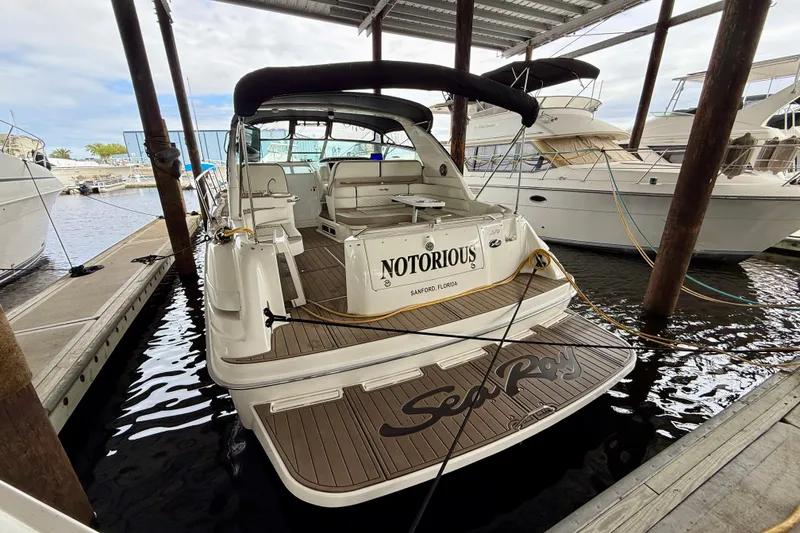 Slide: The Image of 1995 Sea Ray Sundancer 370 docked, featuring spacious deck and elegant design. - 42