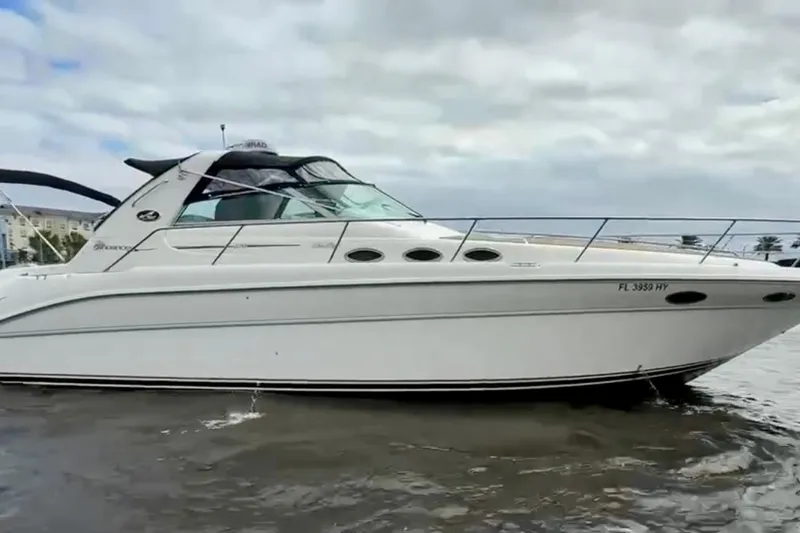 Slide: The Image of 1995 Sea Ray Sundancer 370 yacht on water, showcasing sleek design and luxury features. - 44