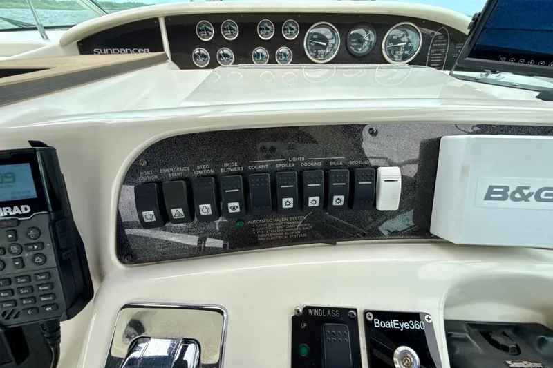 Slide: The Image of Control panel of a 1995 Sea Ray Sundancer 370 boat with switches and gauges. - 48