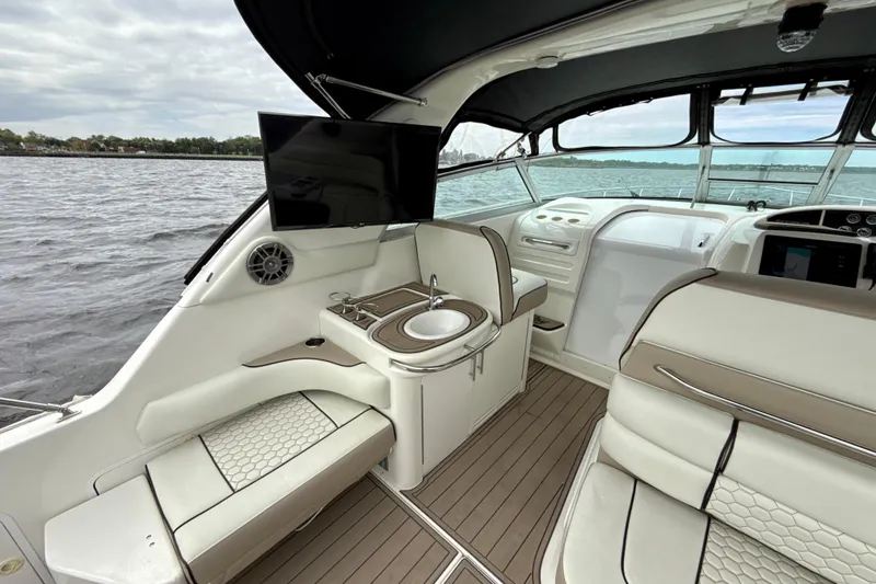 Slide: The Image of Interior of a 1995 Sea Ray Sundancer 370 yacht with seating and a small sink. - 51