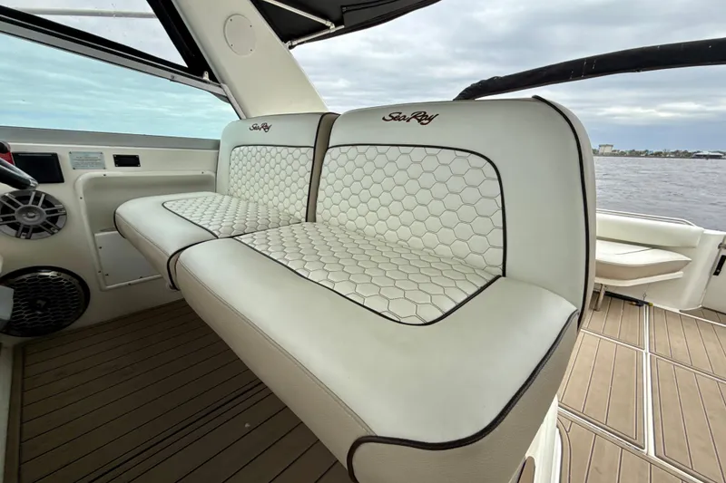 Slide: The Image of 1995 Sea Ray Sundancer 370 interior with white hexagonal-patterned seating and wood-style flooring. - 8