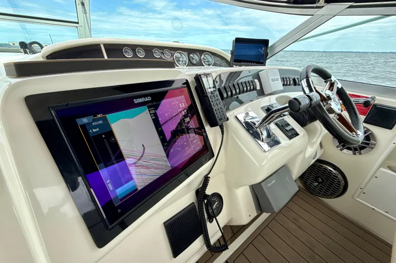 Slide: The Image of 1995 Sea Ray Sundancer 370 helm with modern navigation equipment and ocean view. - 9