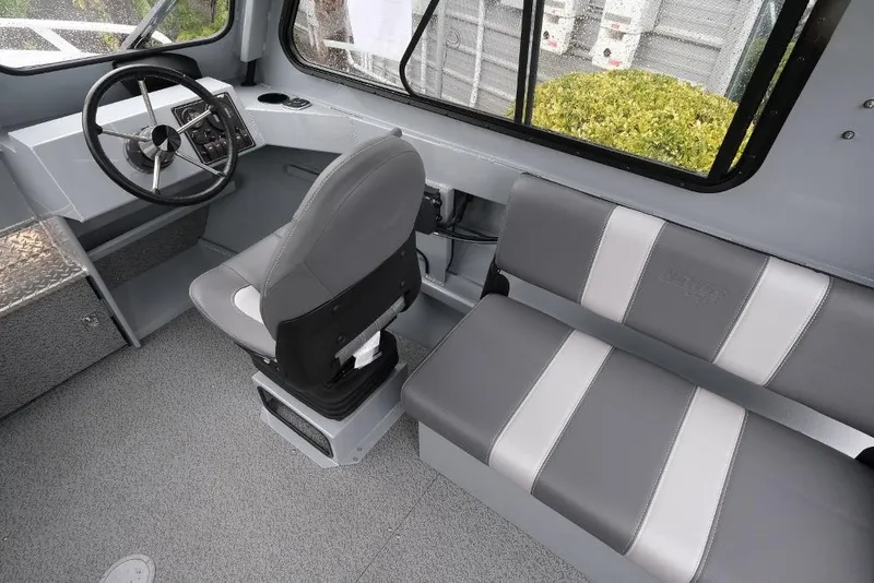 Slide: The Image of Interior of 2026 Hewescraft 200 ProV boat with steering wheel and seating. - 11