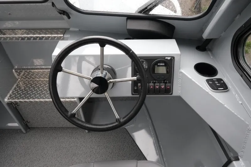 Slide: The Image of Interior view of 2026 Hewescraft 200 ProV boat cockpit with steering wheel and controls. - 13