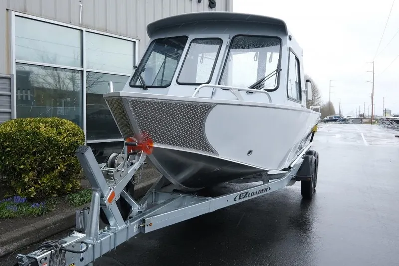 Slide: The Image of 2026 Hewescraft 200 ProV boat on trailer outside a building. - 3