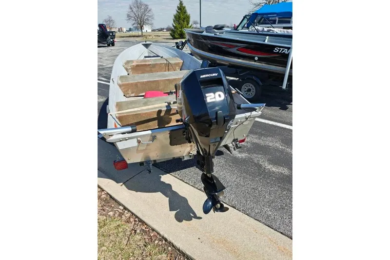 Slide: The Image of 1986 Grumman Car Topper 14 boat with Mercury 20 outboard motor on trailer. - 7