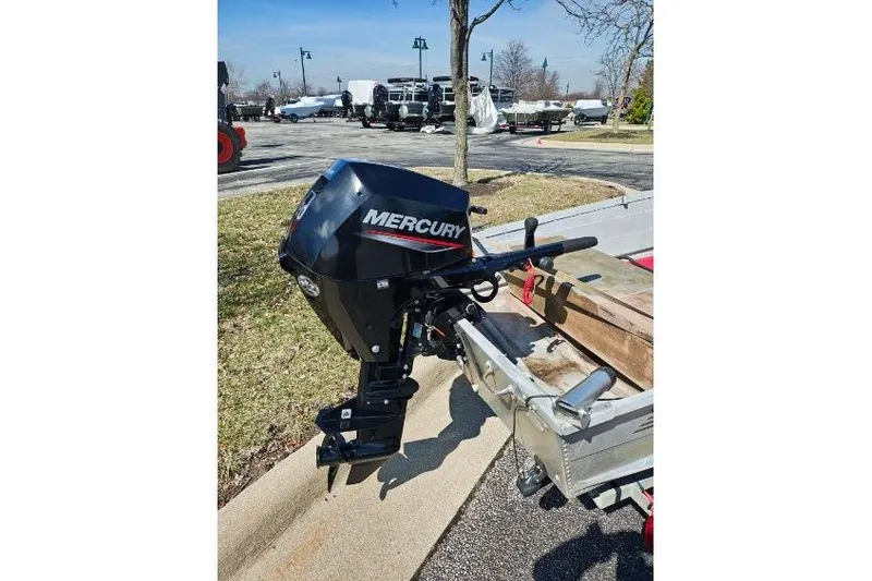 Slide: The Image of 1986 Grumman Car Topper 14 with Mercury outboard motor on a trailer. - 8