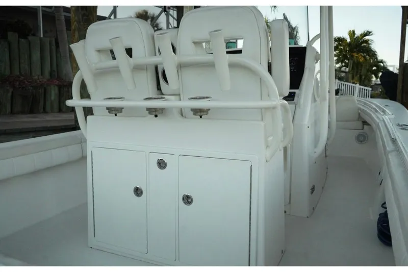Slide: The Image of 2018 Regulator 28 boat interior with white seating and storage compartments. - 13