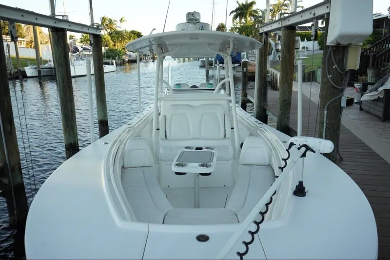 Slide: The Image of 2018 Regulator 28 boat docked, featuring spacious seating and sleek design. - 32