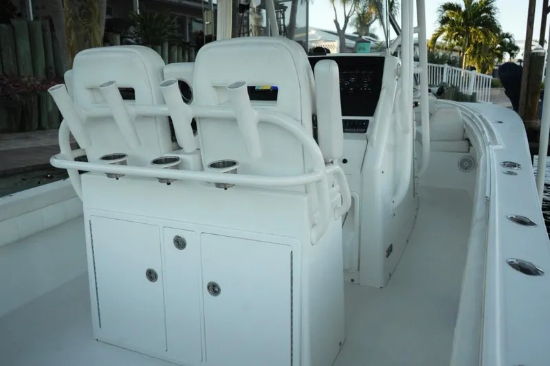Slide: The Image of 2018 Regulator 28 boat interior with rod holders and seating. - 6