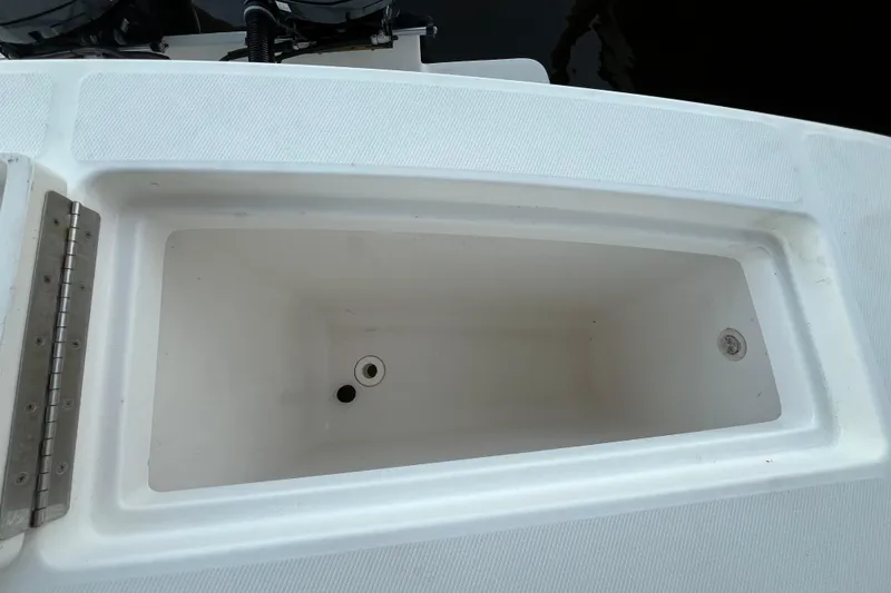 Slide: The Image of Open storage compartment on 2018 Regulator 28 boat, featuring a clean, white interior. - 7